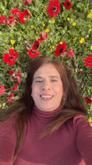 Woman rests in poppy field near Kibbutz Ruhama