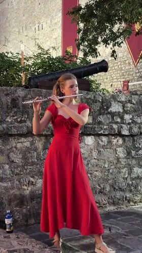 Flute performance at Budva's historic walls, dusk to night