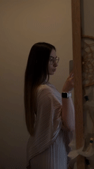 Woman documents mirror selfie session in pink outfit