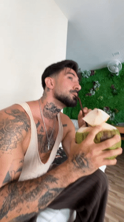Couple shares coconut drinks in Kathu Thailand indoor setting