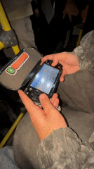 Bus passenger plays PSP racing game in Buenos Aires
