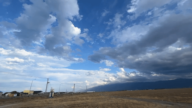 Storm clouds gather over Kazakhstan's open steppe and mountains