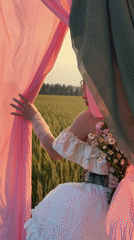 Bridal-style photoshoot in a Russian wheat field at golden hour