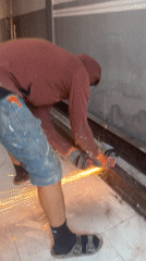 Angle grinder cutting metal beams in Roubaix, sparks flying