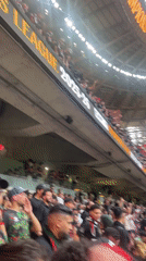 Soccer fans gather at Rabat stadium waving flags