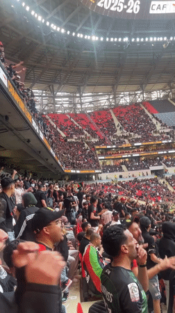 Soccer fans gather at Rabat stadium waving flags