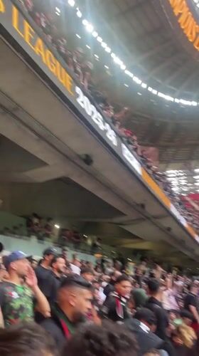 Soccer fans gather at Rabat stadium waving flags