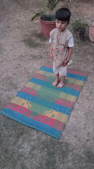 Young boy performs outdoor prayer in Pakistan backyard