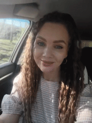 Woman and child photographed in car during afternoon