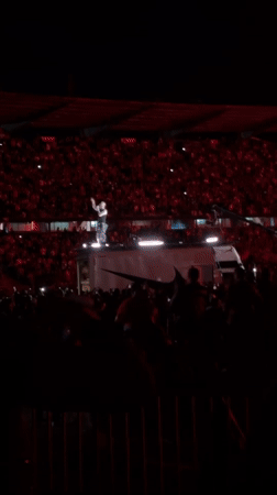 Nighttime stadium concert features performer on Nike-branded truck in Medellín