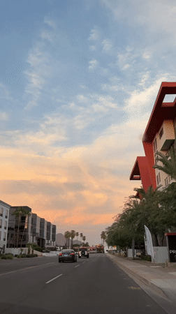 Phoenix street at sunset, palm trees and a painted sky