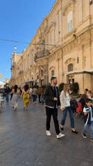 Tourist activities documented in baroque Noto, Italy during midday