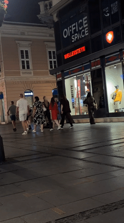 Street violinist performs for evening pedestrians in Belgrade