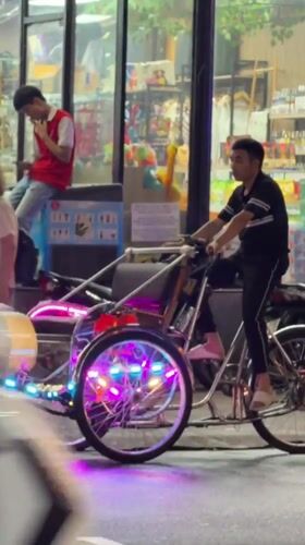 Nha Trang's night market scene: lanterns, cyclos, and tropical fruit stalls