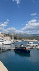 Sunny afternoon marina activity recorded in Radovići, Montenegro