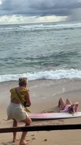 Women photographing on Ahangama beach, Sri Lanka