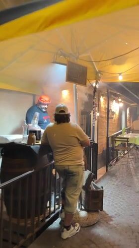 Evening street life and dining captured in Catania, Italy
