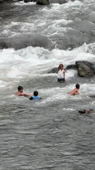 Children play in rocky rapids, Klungkung river, Indonesia