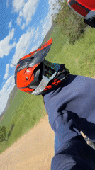 Dirt bike riders traverse grassy field in Bulgaria