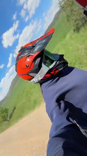 Dirt bike riders traverse grassy field in Bulgaria