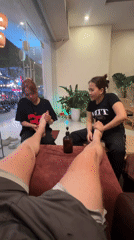 Person receives dual foot massage, films experience