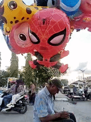 Man sits on barrier with object in Lhokseumawe