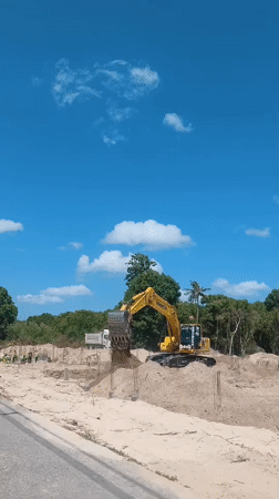 Excavator digging through sandy construction site in Ko Samui