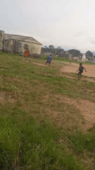 Pickup soccer on a dusty field in Serti, Nigeria