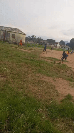 Pickup soccer on a dusty field in Serti, Nigeria