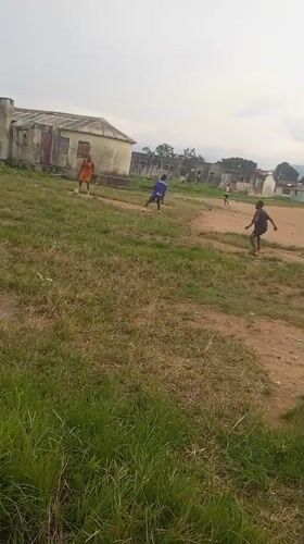 Pickup soccer on a dusty field in Serti, Nigeria