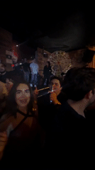 Young adults gather at Puebla restaurant, woman wears traditional sombrero