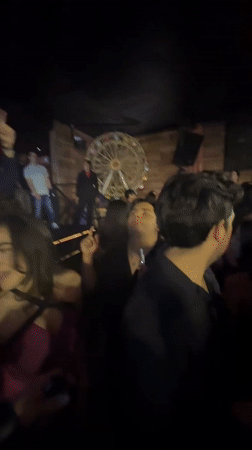 Young adults gather at Puebla restaurant, woman wears traditional sombrero