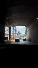 Vehicle exits tunnel past angel statues in Puebla