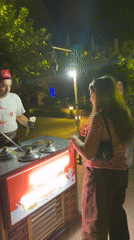 Ice cream vendor works a colorful street cart in Serik, Turkey