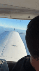 Two small planes fly in close formation over Southern California