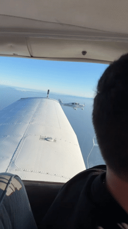 Two small planes fly in close formation over Southern California