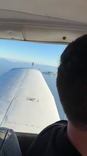Two small planes fly in close formation over Southern California