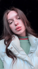 Woman spotted in Moscow displaying fresh manicure, green sweater
