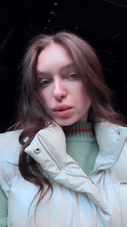 Woman spotted in Moscow displaying fresh manicure, green sweater