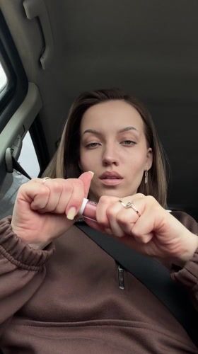 Woman applies makeup in car in Minino, Russia