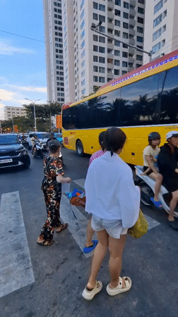 Busy beach morning in Nha Trang, streets and shoreline both packed