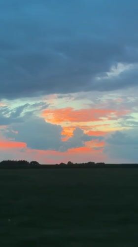 Sunset over rural Bavaria, viewed from a moving car.