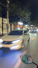 Motorcycle rider documents nighttime traffic in Đồng Nai, Vietnam