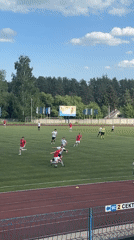 Soccer match played in Chaikovsky stadium with spectators watching