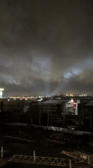 Searchlights illuminate cloudy skies over Yekaterinburg at night