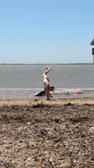 Handstands and sunshine on a pebbly UK beach