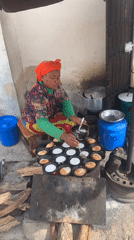 Woman cooks round cakes outdoors in Jos, Nigeria