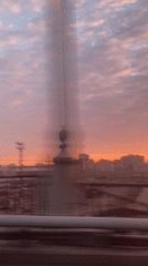 Sunset sky captured over Moscow skyline from moving vehicle