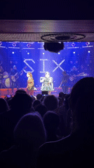 Live band performance draws phone-wielding audience in London