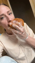 Woman enjoys multiple burgers indoors in Saint Petersburg